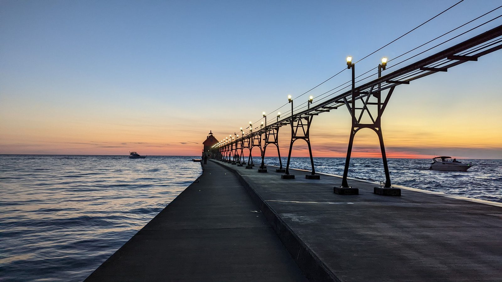Pier and lighthouse on Lake Michigan at sunset